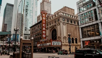 A downtown Chicago street with high-rise towers and the Chicago Theatre sign